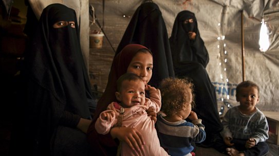 Australian Maysa assaad aged 9 years old (3rd from left) holding Shayma Assaadâs daughter Mariam (2nd from left) in al Hawl camp in North East Syria. There are 20 Australian women and 46 Australian children detained in al Hawl camp for their association with Islamic State fighters. They are living in squalid conditions and are afraid of the war that started when Turkey invaded the Kurdish region known as Rojava in North East Syria, Syria. 21st October, 2019. Photo: Kate Geraghty/SMH .