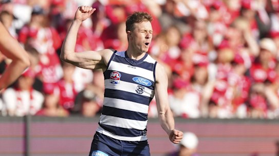 Mitch Duncan of the Cats celebrates after kicking a goal.