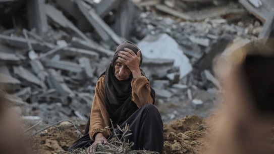 A Palestinian woman among rubble after Israeli shelling in the Nuseirat refugee camp in central Gaza last week.