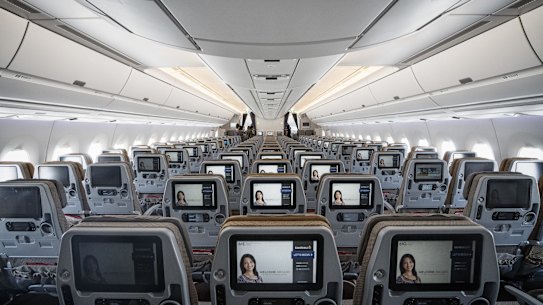 Entertainment monitors sit on the back of passenger seats in the economy class cabin of an Airbus SE A350 aircraft, operated by Singapore Airlines Ltd., during an arrival ceremony at Changi Airport in Singapore, on Thursday, March 3, 2016. Singapore Air, hurt by competition from opulent Middle Eastern carriers and a rash of budget airlines, is trying to revive its fortunes the way it knows best: wooing flyers with new aircraft. While the new aircraft with its extra-wide cabins and a new entertainment system will set Singapore Air apart from local rivals, it might be too little, too late to turn around its fortunes. Photographer: Bryan van der Beek/Bloomberg via Getty Images