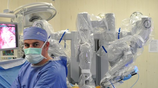 Professor Declan Murphy with a surgical robot.