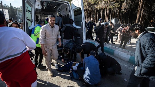 People taking care of the injured after an explosion in Kerman, Iran.