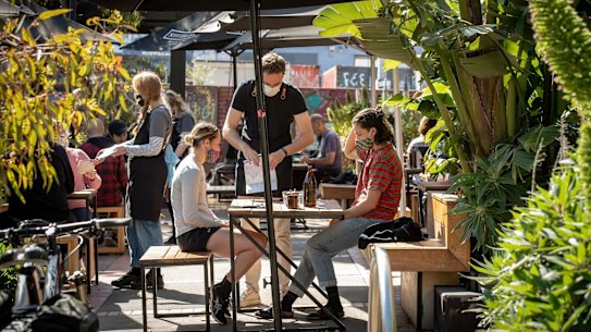 Customers enjoy dining at their local cafe in Brunswick.