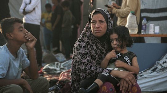 A Palestinian woman and children in the courtyard of the Al Aqsa Martyrs Hospital in Deir al-Balah, central Gaza, following an Israeli strike.