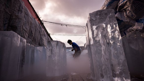 A man unloads blocks of ice from a truck during a heatwave in Bangkok, Thailand, on Sunday.