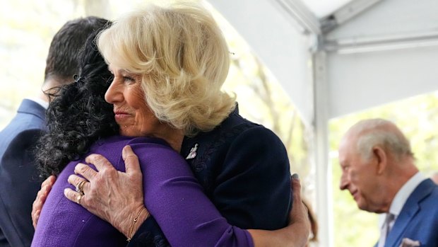 The Queen embraces a relative of a victim of the 9/11 attacks at the memorial.