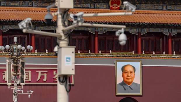 Security cameras in front of a portrait of former Chinese leader Mao Zedong at Tiananmen Square.