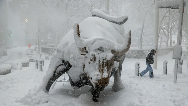 Snow covers the famous Charging Bull.