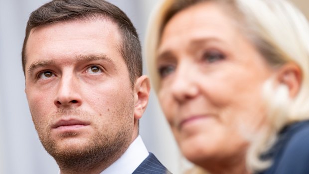 Jordan Bardella, president of France’s National Rally, left, wirth party leader Marine Le Pen.