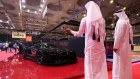 Attendees view the Entop Simurgh supercar at the Geneva International Motor Show in Doha, Qatar.