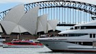 People stand on the deck of a Captain Cook Cruise vessel. The company is being sold to Journey Beyond.