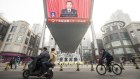 A screen displays a news broadcast of Li Keqiang, China’s premier, during the opening of the First Session of the 14th National People’s Congress (NPC) at the Great Hall of the People in Beijing.