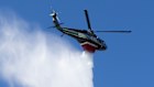 A helicopter drops water on the Palisades Fire in Los Angeles in January. 