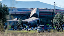 Emergency services attend to the victims at the scene of a collision between two trains in Urda, Spain.