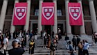Students take photos on the steps of the Harry Elkins Widener Memorial Library at Harvard University.