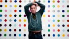 Damien Hirst with one of his spot paintings. The artist has now created 10,000 artworks that can be NFTs.