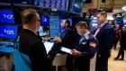 Traders in New York. Markets are awaiting a decision on whether tariffs on Canada and Mexico proceed this week.