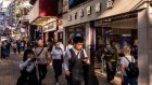 Pedestrians in Hong Kong’s Tsim Sha Tsui. Consumer and technology groups listed in the city are trading at a big discount, some fund managers say.