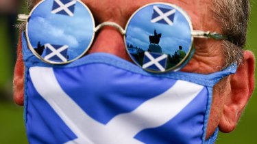BANNOCKBURN, SCOTLAND - AUGUST 19: The reflection is seen in the glasses of a supporter of Scottish independence as they gather at the site of the battle of Bannockburn for an 'All Under One Banner' event on August 19, 2020 in Bannockburn, Scotland. The organisers held a socially distanced rally in support for Indy Ref2 at the site of the Battle of Bannockburn, where the army of the King of Scots Robert the Bruce defeated the army of Englands King Edward II in 1314, during the first war of Scottish Independence. (Photo by Jeff J Mitchell/Getty Images) *** BESTPIX ***