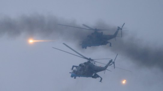 Military helicopters fly over the Osipovichi training ground in Belarus, on February 17.