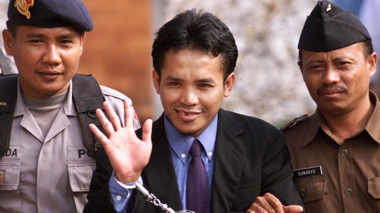 Ali Imron waving to journalists after his sentencing in 2003. He was spared the death penalty because of his remorse and cooperation with authorities. 