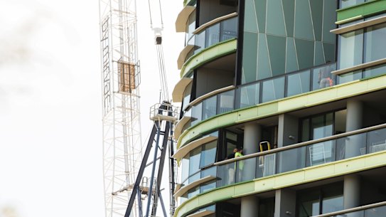 Tradesmen work on Opal Tower in Olympic Park which was evacuated earlier in the week in Homebush, Sydney on December 27, 2018. Photo: Dominic Lorrimer
