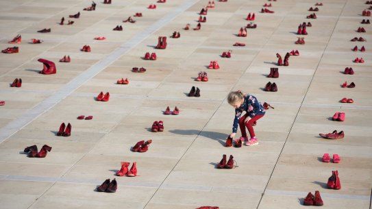 A display of hundreds of red shoes spread as protest against violence toward women in Israel at Habima Square in Tel Aviv, Israel, Tuesday, Dec. 4, 2018. A nationwide strike in protest of violence against women commemorating the 24 victims of domestic violence with thousands of men and women calling on the government to take action against domestic abuse. (AP Photo/Oded Balilty)