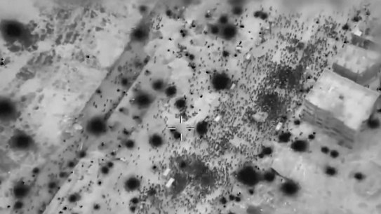 A screen grab taken from video and released by the Israeli army of Palestinians surrounding aid trucks in northern Gaza.