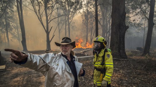Taree South resident Carl Silver with Firefighter Adam Brown.