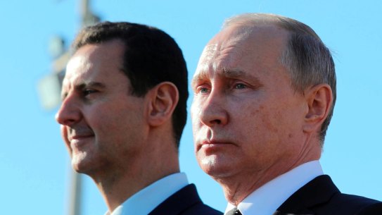 Russian President Vladimir Putin, right, and Syrian President Bashar Assad watch troops marching at the Hemeimeem air base in Syria in 2017.