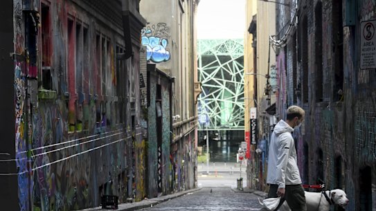 A man walks past Melbourne’s Hosier Lane during lockdown last August.