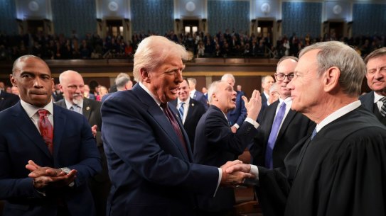President Donald Trump greets John Roberts, Chief Justice of the Supreme Court, at the US Congress.