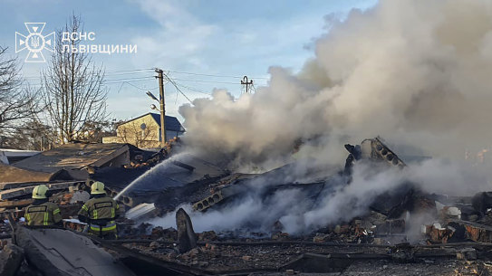 In this photo provided by the Ukrainian Emergency Service, emergency services personnel work to extinguish a fire following a Russian rocket attack in Lviv, Ukraine, on Sunday.