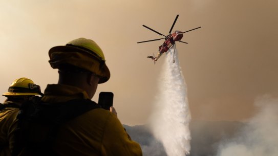 A helicopter drops water on the Palisades fire in Los Angeles at the weekend.