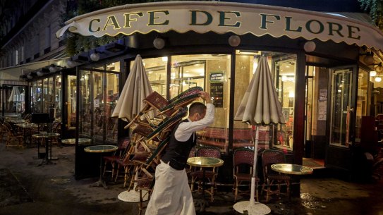 A waiter packs up at the end of the day at Cafe de Flore on the last day before new COVID-19 restrictions force bars and cafes in Paris to close for a minimum of two weeks on October 5.
