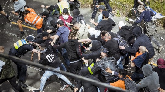 Anti-authority protestors clash with Victoria police at an Anti-Lockdown rally in Richmond.

