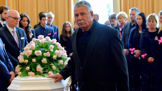 George Halvagis, father of Mersina, touches the coffin of Doncaster teenager Masa Vukotic at her funeral.