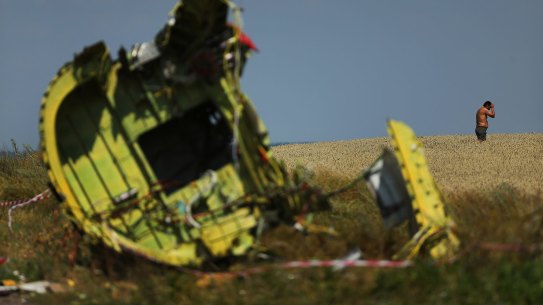 A Ukrainian man stands in the field where he came across a diver's watch near debris from the MH17 plane crash outside the village of Grabovka in the self-proclaimed Donetsk Republic, Ukraine. 