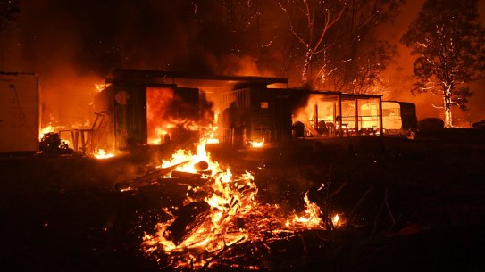 Firefighter overwhelmed by flames at bushfire in Orangeville, 5 December 2019. Photo Nick Moir