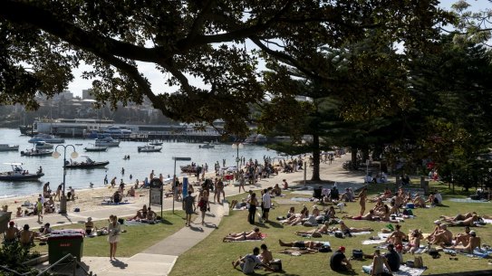 People relaxing in the sun in Manly, in Sydney’s northern beaches, on the weekend before restrictions are eased.