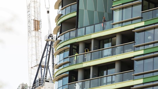 Tradesmen work to fix the cracking at Opal Tower that caused residents to be evacuated twice in a week.