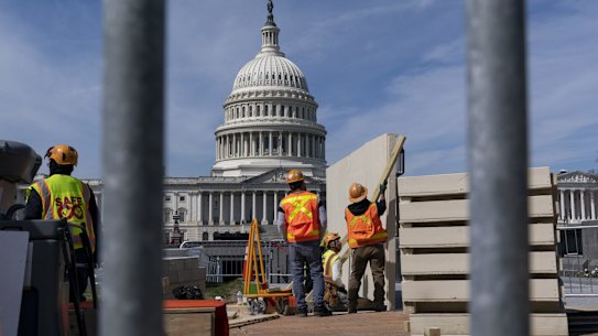 Workers construct and erect panels on the East side of the Capitol in Washington, Tuesday, March 21, 2023. (AP Photo/J. Scott Applewhite)