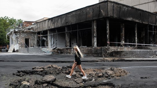VINNYTSIA, UKRAINE - JULY 15: A young woman walks over a hole made by a rocket on July 15, 2022 in Vinnytsia, Ukraine. Scores of people were also wounded in the attack, in which rockets hit a multistory building in the city's center. Vinnytsia had not been the target of significant attacks since early March. (Photo by Alexey Furman/Getty Images) *** BESTPIX ***
