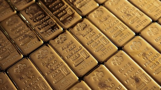 Gold has raced to a record high as investors fled for safe assets.