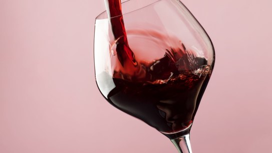French dry red wine, pours into glass, trendy pink background, space for text, selective focus Red wine generic
iStock