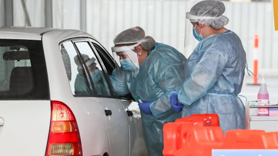 A nurse conducts a COVID-19 test at a drive-through facility in Geelong. 
