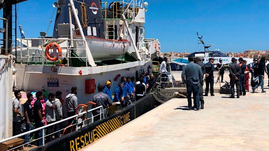 Rescued migrants desembark from the Mare Jonio rescue ship of the Italian NGO Mediterranea Saving Humans as it docked at the port of the Italian island of Lampedusa, southern Italy.