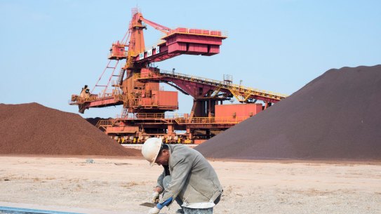 November 11, Taicang, China - A worker tends to tracks used to transport iron ore from stockpiles at Taicang Port, around an hour and a half out of Shanghai. Iron ore has sunk to its lowest price in 5 years: US$70 per tonne.