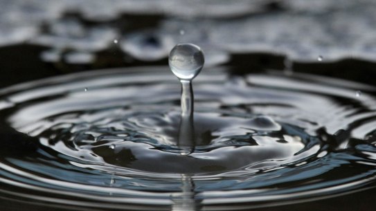 A formation visible for hundredth of a second as a drop of water falling from a melting icicle plashes into a puddle in Pomaz, 20 kms north of Budapest, Hungary, Saturday, Jan. 9, 2016. (Attila Kovacs/MTI via AP)