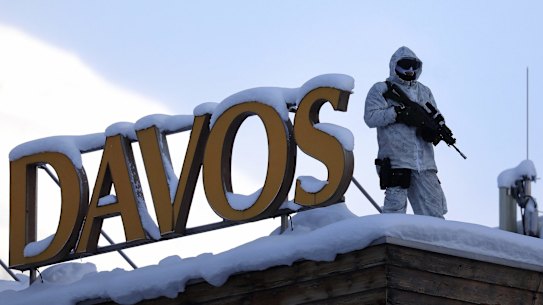 An armed member of the Swiss Police watches from the roof of the Hotel Davos ahead of the World Economic Forum (WEF) in Davos, Switzerland.